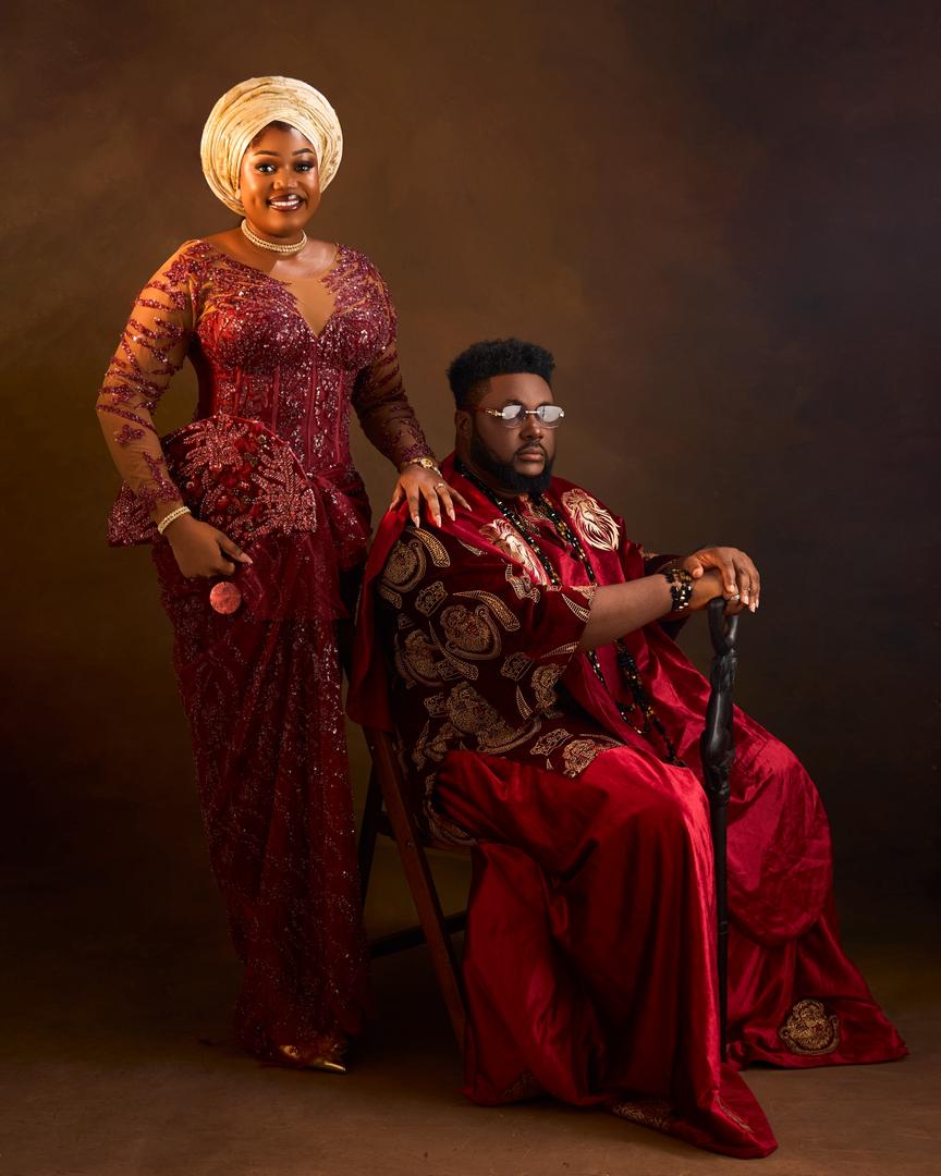 Couple in emerald-green Igbo attire with coral beads